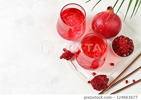 Fruit juice and ingredients, summer drink or tonic with pomegranate and ice on bright table, detox diet and weight loss concept, healthy and natural food, source of vitamin C, selective focus Fruit juice and ingredients, summer drink or tonic with pomegranate and ice on bright table, detox diet and weight loss concept, healthy and natural food, source of vitamin C, selective focus 124663677