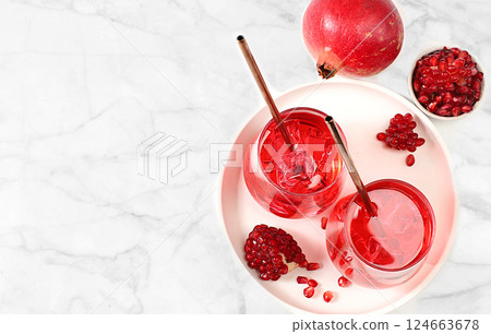 Fruit juice and ingredients, summer drink or tonic with pomegranate and ice on bright table, detox diet and weight loss concept, healthy and natural food, source of vitamin C, selective focus 124663678