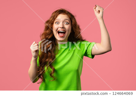 Pretty woman shows triumph yes gesture of victory, she achieved result, goals 124664069