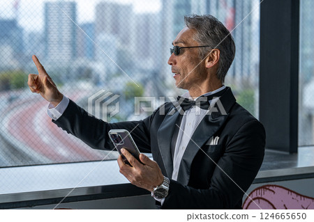 A CEO venting his anger over the phone in his office in an office building A CEO venting his anger over the phone in his office in an office building 124665650