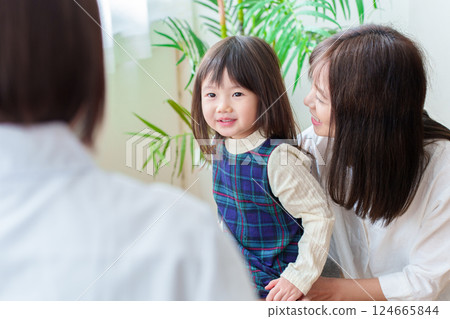 Girl receiving medical examination, pediatrician and mother Girl receiving medical examination, pediatrician and mother 124665844