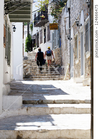 Tourists walking along a narrow street on the Greek island of Hydra 124666475