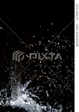 Vertical composition of water splashes and black background Vertical composition of water splashes and black background 124667283