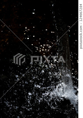Vertical composition of water splashes and black background Vertical composition of water splashes and black background 124667284