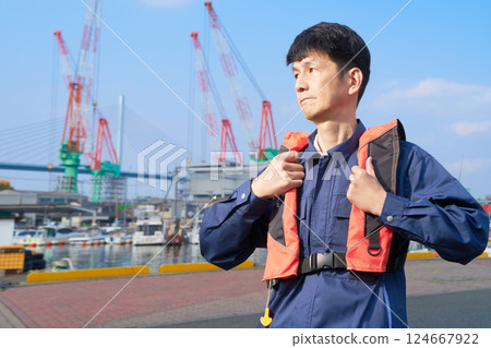 Dock workers wearing life jackets 124667922