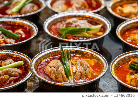 Cooked brains with chili pepper sauce in aluminium tubs Sichuan snacks 124668036
