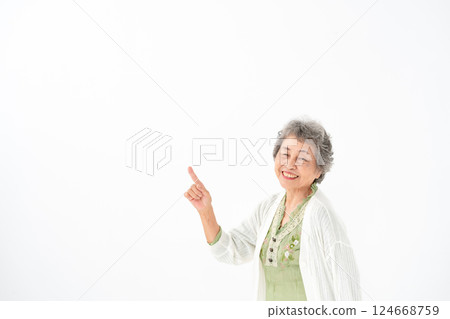 Senior woman portrait pointing 124668759