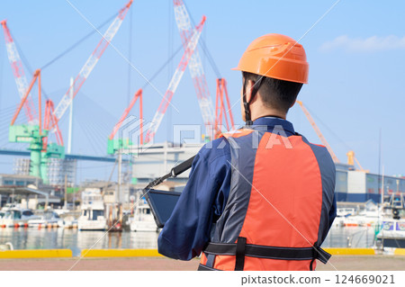 Male worker engaged in port work 124669021