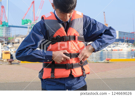 Man wearing a life jacket Man wearing a life jacket 124669026