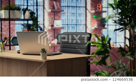 High end modern apartment with a home office desk used for remote job, trendy urban loft decorated with stylish furniture and indoor plants. Empty studio space with wooden floors. 124669536