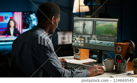 Video maker producing montage with artistic software for color adjustment, special effects in movie editing. Digital media illustrator developing transitions for cinematic production. Camera B. Video maker producing montage with artistic software for color adjustment, special effects in movie editing. Digital media illustrator developing transitions for cinematic production. Camera B. 124669545