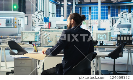 Expert leaves desk after designing production lines for solar panel assembly photovoltaics factory, starting work. Technician ready to work after consulting factory production layouts 124669552