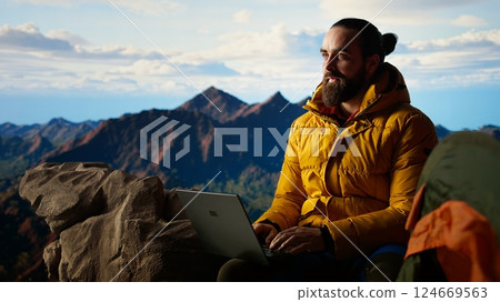 Modern online entrepreneur with technology reliance on a mountain top, always connected workaholic hiker admires the scenic landscape. Remote access high connectivity. Camera A. Modern online entrepreneur with technology reliance on a mountain top, always connected workaholic hiker admires the scenic landscape. Remote access high connectivity. Camera A. 124669563