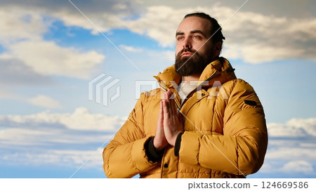 Calm peaceful explorer doing meditation session for stress relief in nature, relaxing for wellness and balance on top of the mountain. Young hiker traveler meditating for mindfulness. Camera B. Calm peaceful explorer doing meditation session for stress relief in nature, relaxing for wellness and balance on top of the mountain. Young hiker traveler meditating for mindfulness. Camera B. 124669586