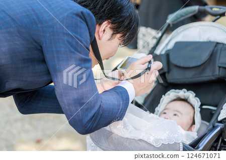 Dad taking a photo of his child at shrine visit Dad taking a photo of his child at shrine visit 124671071