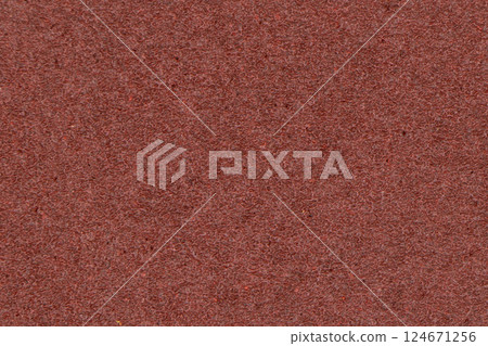 The structure of the sandpaper surface. Sandpaper texture background with pattern of red sand grains. Abrasive material texture 124671256