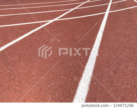 Red treadmill with the lines at the stadium. Treadmill lane on sport field. Running track on the stadium. Red treadmill in sport field. Running track Red treadmill with the lines at the stadium. Treadmill lane on sport field. Running track on the stadium. Red treadmill in sport field. Running track 124671286