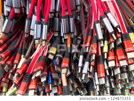 Different types of charger connectors for phones texture background. Charging or data cables. 124671331