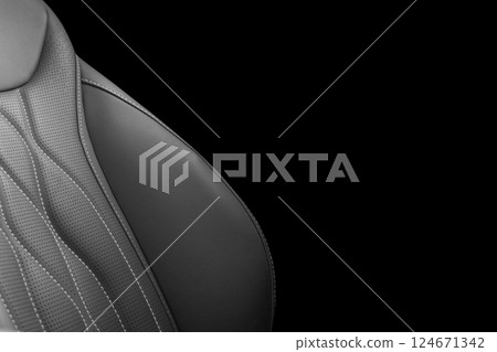 Black leather interior of the luxury modern car. Perforated black leather. Seats with stitching isolated on black background. Modern car interior details. Car inside Black leather interior of the luxury modern car. Perforated black leather. Seats with stitching isolated on black background. Modern car interior details. Car inside 124671342
