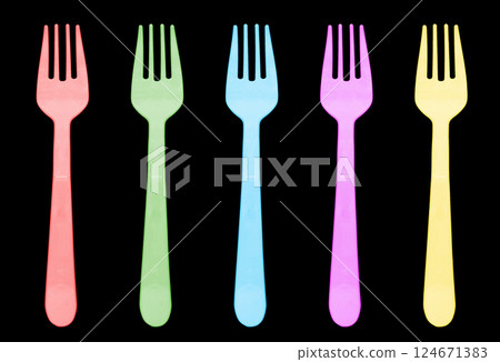 Multi color plastic fork isolated on black background. Disposable tableware set isolated Multi color plastic fork isolated on black background. Disposable tableware set isolated 124671383