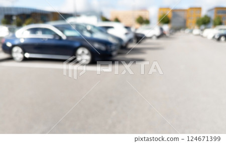 Blurred background with cars on the street. Bokeh lights background. Abstract blur car parking lot for background. Blurred cars parking. 124671399