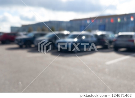 Blurred background with cars on the street. Bokeh lights background. Abstract blur car parking lot for background. Blurred cars parking. 124671402