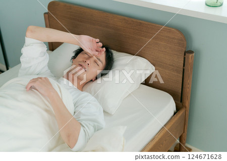 A man sleeping in bed A man sleeping in bed 124671628