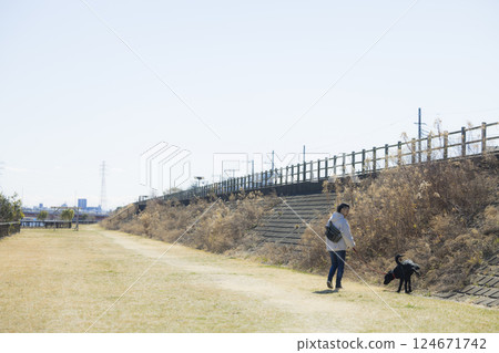 Man walking a dog Man walking a dog 124671742