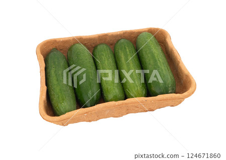 Fresh green cucumber in paper disposable box isolated on white background. Cucumber isolated over white. Fresh green cucumber in paper disposable box isolated on white background. Cucumber isolated over white. 124671860