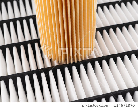 Oil filter, air filter texture background. Spare parts of a car. Quality spare parts for car service or maintenance. Auto parts accessories 124671870