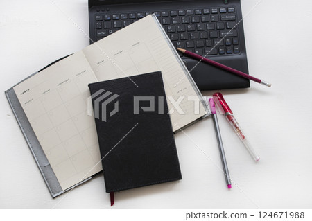 notebook planner with computer for business work  124671988