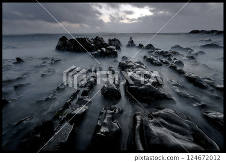 Long exposure landscape, dark sunset, low angle, rocky coast 124672012