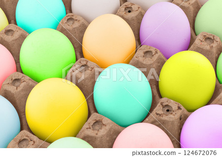Easter eggs in wooden box texture background. Rainbow colored Easter eggs pattern. Group of easter eggs in a row. Easter eggs in wooden box texture background. Rainbow colored Easter eggs pattern. Group of easter eggs in a row. 124672076