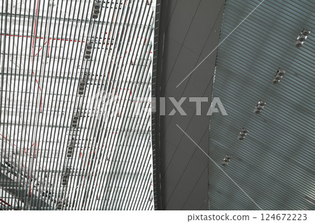 Lights and ventilation system in long line on ceiling of the industrial building. Exhibition Hall. Ceiling factory construction Lights and ventilation system in long line on ceiling of the industrial Lights and ventilation system in long line on ceiling of the industrial building. Exhibition Hall. Ceiling factory construction Lights and ventilation system in long line on ceiling of the industrial 124672223