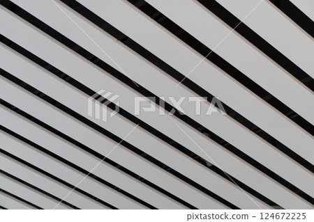 Lights and ventilation system in long line on ceiling of the industrial building. Exhibition Hall. Ceiling factory construction Lights and ventilation system in long line on ceiling of the industrial Lights and ventilation system in long line on ceiling of the industrial building. Exhibition Hall. Ceiling factory construction Lights and ventilation system in long line on ceiling of the industrial 124672225