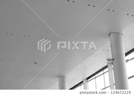 Lights and ventilation system in long line on ceiling of the industrial building. Exhibition Hall. Ceiling factory construction Lights and ventilation system in long line on ceiling of the industrial Lights and ventilation system in long line on ceiling of the industrial building. Exhibition Hall. Ceiling factory construction Lights and ventilation system in long line on ceiling of the industrial 124672229