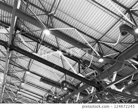 Lights and ventilation system in long line on ceiling of the industrial building. Exhibition Hall. Ceiling factory construction. Lights and ventilation system in long line on ceiling of the industrial building. Exhibition Hall. Ceiling factory construction. 124672243