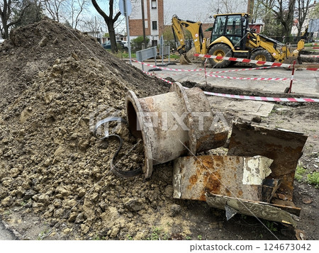 Broken large metal pipe at the construction site 124673042