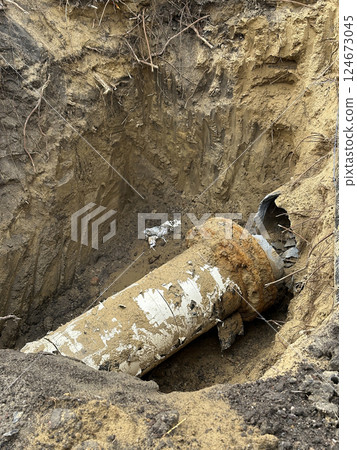 Broken large metal pipe at the construction site 124673045