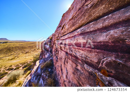 Pink Striated Rock in Desert Landscape with Sunlit Texture Perspective 124673354