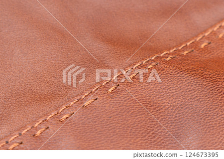 Leather texture background. Part of perforated brown leather details. Perforated leather texture background. Texture leather 124673395