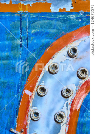Weathered Bolts on Vintage Machinery with Peeling Paint Close-Up 124673575