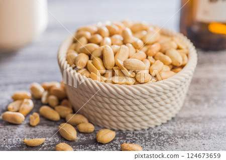 Roasted salted peanuts in bowl on kitchen table Roasted salted peanuts in bowl on kitchen table 124673659