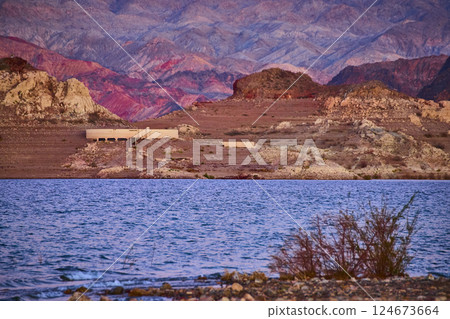 Golden Desert Lake and Abandoned Structure at Sunset Eye Level 124673664