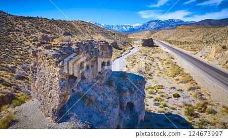 Aerial of Rugged Desert Rock Formations and Mt Charleston Snowcaps Aerial of Rugged Desert Rock Formations and Mt Charleston Snowcaps 124673997