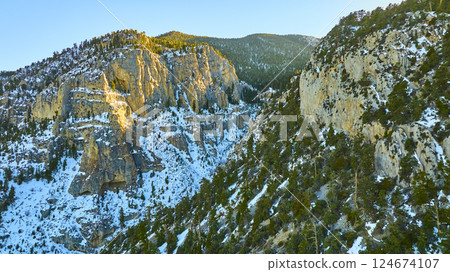 Aerial Fly Over Snowy Mt Charleston Cliffs at Golden Hour Aerial Fly Over Snowy Mt Charleston Cliffs at Golden Hour 124674107