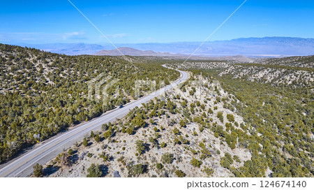 Aerial of Winding Desert Road Through Nevada Mountains Aerial of Winding Desert Road Through Nevada Mountains 124674140