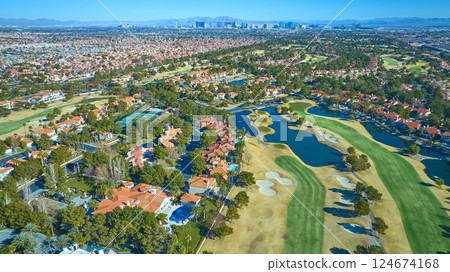 Aerial of Las Vegas Suburb with Golf Course and Skyline Backdrop 124674168