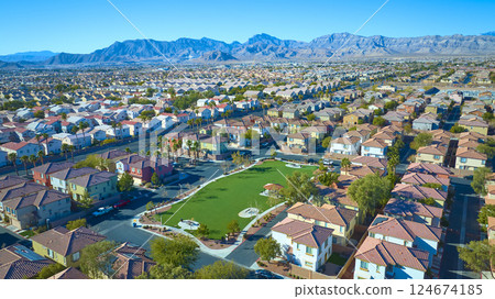 Aerial Suburban Oasis with Desert Mountain Backdrop in Golden Light Aerial Suburban Oasis with Desert Mountain Backdrop in Golden Light 124674185