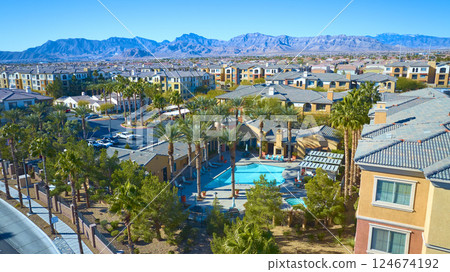 Aerial of Desert Suburban Community with Pool and Mountain Backdrop 124674192